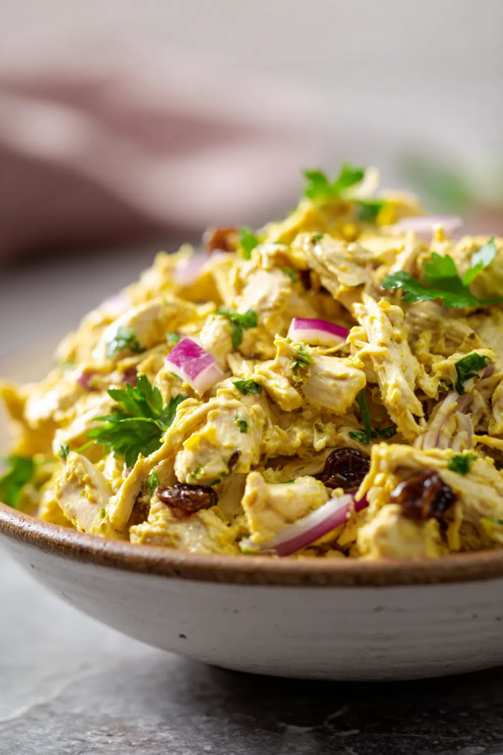 Curry chicken salad being served in various ways - in a wrap, on lettuce leaves, and as a sandwich filling