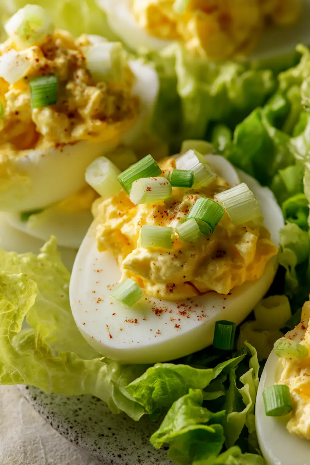 Egg salad recipe served in multiple ways - on bread, in lettuce cups, and as a side dish