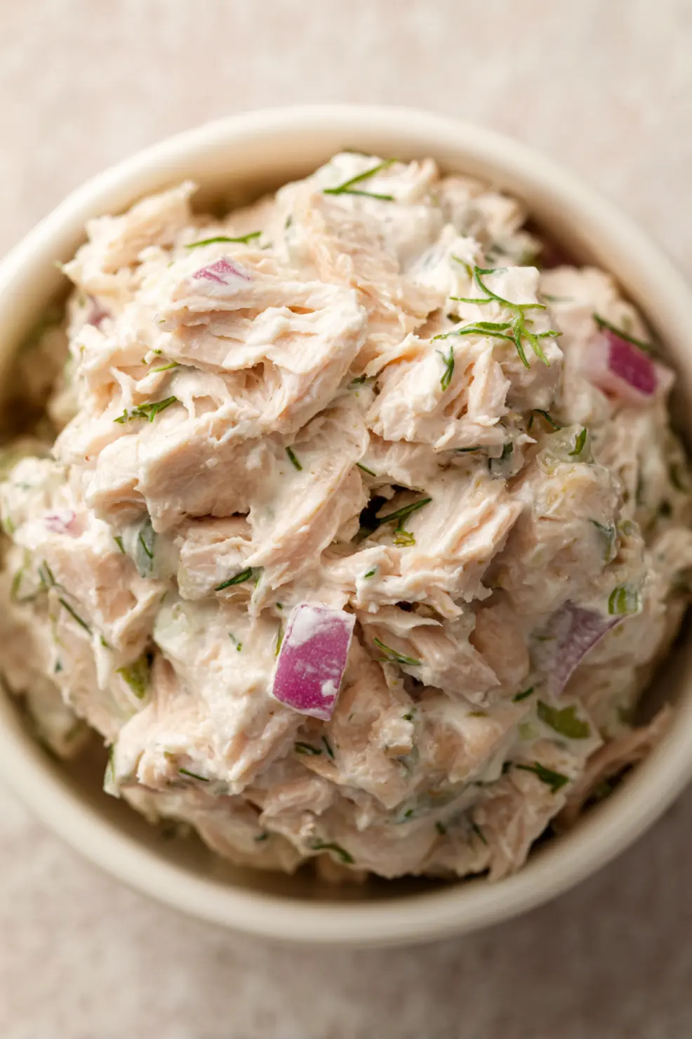 Tuna salad with Greek yogurt served in lettuce cups with lemon wedges and fresh herbs