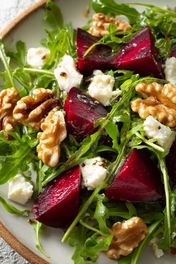 Completed arugula beet salad served in a white bowl showing vibrant colors
