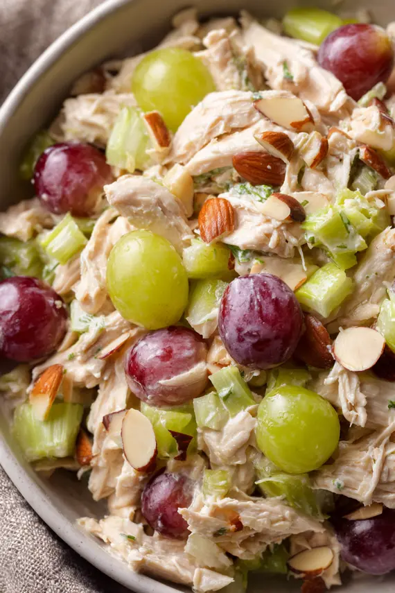 Chicken salad without mayo served in a white bowl with crackers on the side