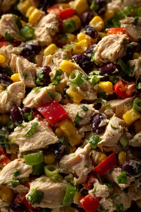 Finished cowgirl chicken salad served in a blue bowl with tortilla chips on the side