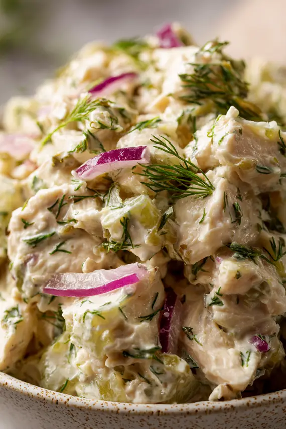 Dill pickle chicken salad served in a bowl with crackers on the side