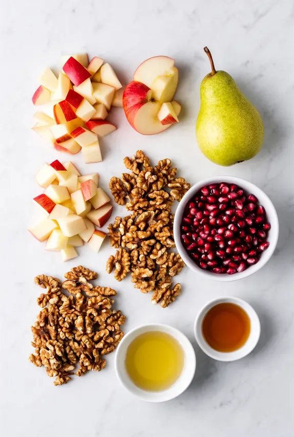 Ingredients for fall fruit salad displayed on a wooden cutting board